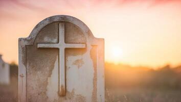 A grave with a cross on it in the grass photo