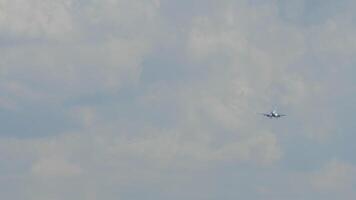 Aircraft approaching landing. Airliner descent. Airplane flying, front view, long shot video
