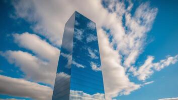 A tall building with a blue sky and clouds photo