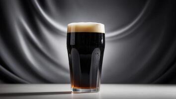 A dark beer in a glass on a table photo