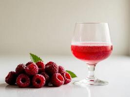 Raspberry juice in a glass with raspberries photo