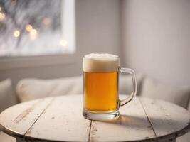 A glass of beer on a table in front of a window photo
