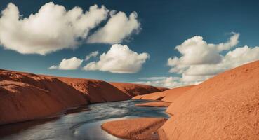 A river flows through a desert with clouds in the background photo