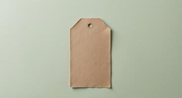 Brown paper tag on green background photo