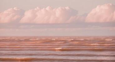 A large body of water with some clouds in the sky photo