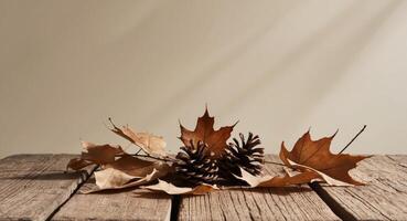 Autumn leaves and pine cones on a wooden table photo