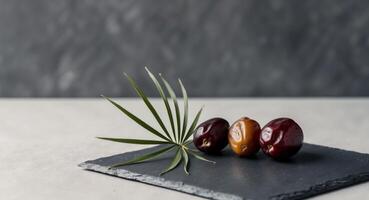 Three dates on a black slate with leaves photo