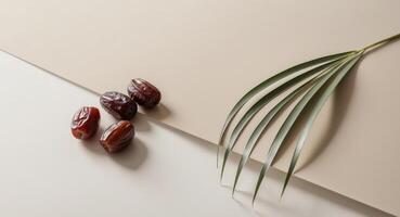 Dates and palm leaf on a beige background photo