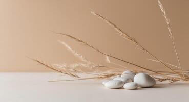 Three white eggs on a table with some grass photo