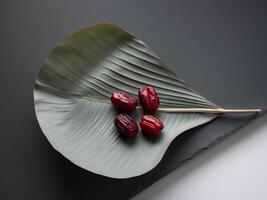 Date palm leaf with red dates on it photo