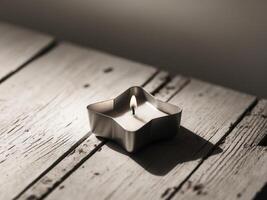 A candle is lit in a small square shaped container photo