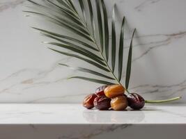 Date palm leaves and dates on marble counter photo
