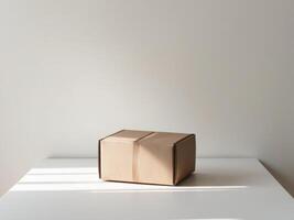 A cardboard box sitting on a table in front of a white wall photo