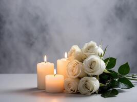 White roses and candles on a table photo