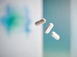White pills falling from the air photo