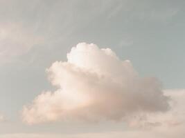 A large cloud is in the sky above a beach photo