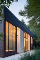 The modern house is surrounded by trees photo