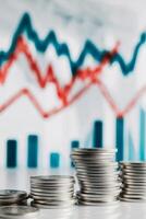 Coins and graphs on a table with a stock chart photo
