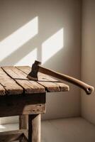 An axe on a table in front of a window photo