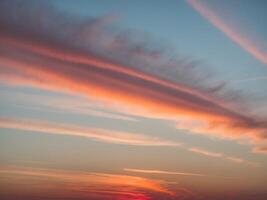 A sunset with clouds and a red sky photo