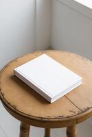 A white book on a wooden table photo