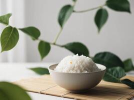 A bowl of rice is placed on a table with a plant photo