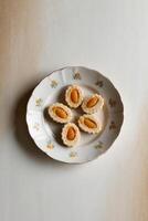 A plate with four small cookies on it photo