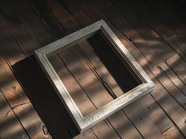 An empty frame on a wooden floor photo