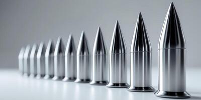A row of sharp metal objects are lined up on a white surface photo