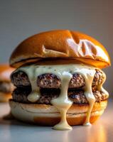 A close up of a hamburger with cheese and sauce photo