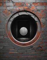 A circular hole in a brick wall photo