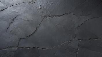 A black stone wall with cracks and cracks photo