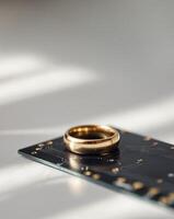 A gold wedding ring on top of a circuit board photo