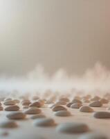 A large group of pebbles on a white surface photo