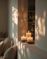 Candles on a shelf in a room with sunlight photo