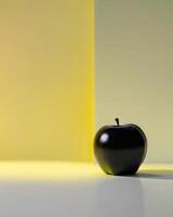 A black apple is sitting on a white surface photo
