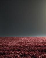 a close up of a textured deep red carpet showcasing its plush fibers photo