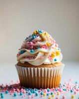 Cupcake with frosting and colorful sprinkles photo