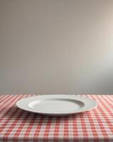 Empty white plate on a checkered red and white tablecloth with ample space for text or design ideas during a casual dining setting photo