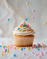 Cupcake with frosting and colorful sprinkles photo