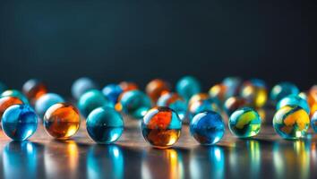 Colorful glass marbles on reflective surface with dark background photo