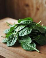 Fresh spinach leaves arranged neatly on wooden surface photo