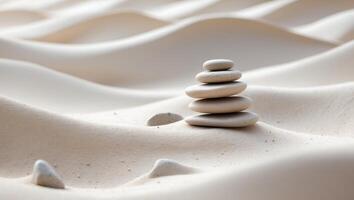 Stacked stones in gentle sand waves create a tranquil landscape of nature photo