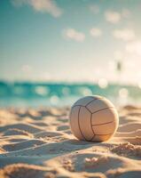 A volleyball ball on the beach with the ocean in the background photo