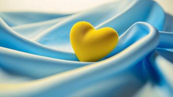 Yellow Heart on Blue Silk Fabric Symbolizing Love and Unity photo