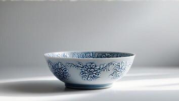 there is a blue and white bowl with a floral design on it photo