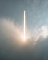 A single beam of light shining through the mist and cloud photo