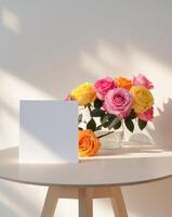 Blank mock up card on the table decorated with colorful roses photo