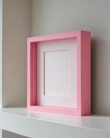 a close up of a pink square frame on a shelf photo