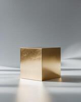 a close up of a golden cube on a gray background photo